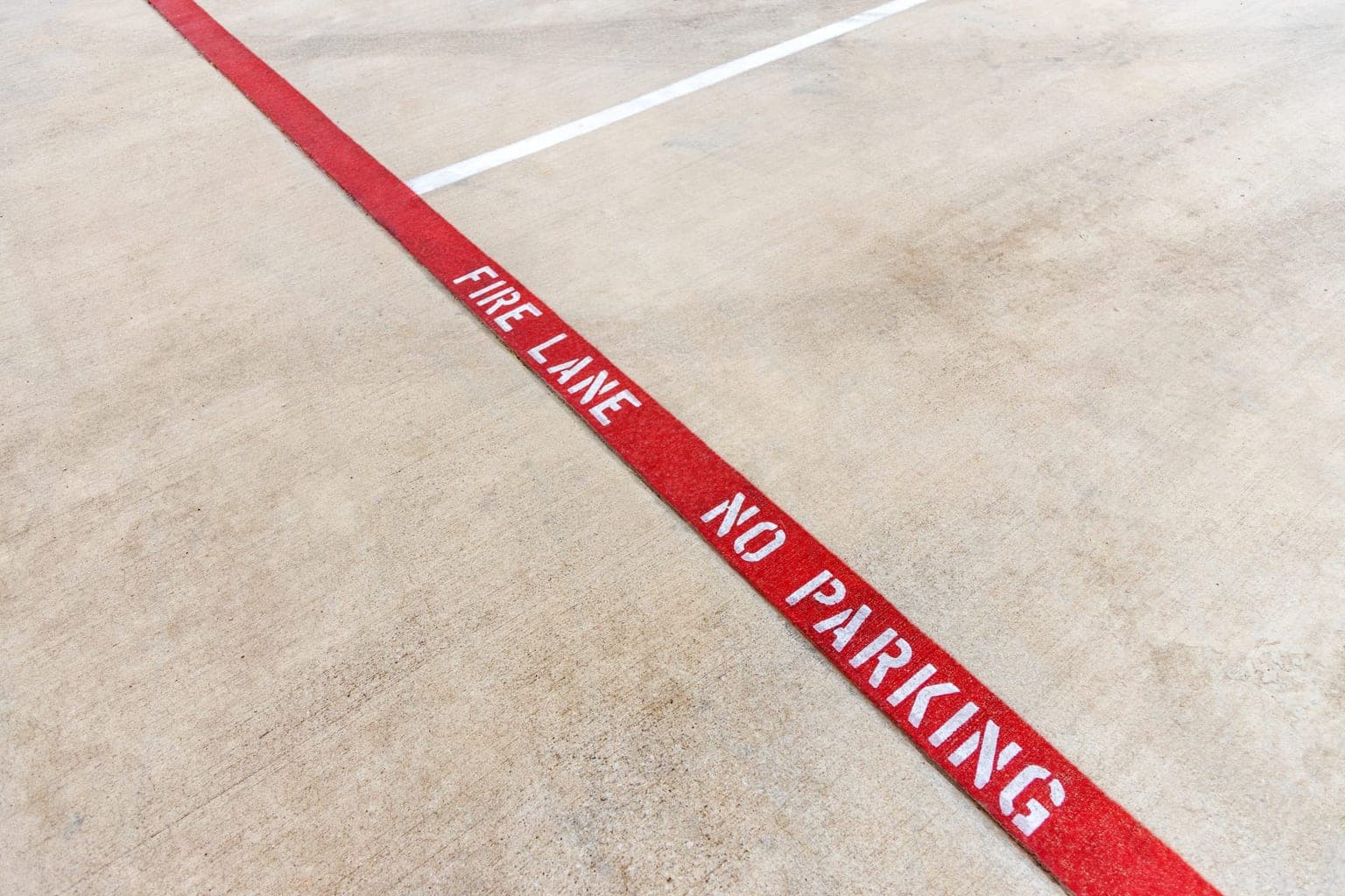 Red fire lane and no parking markings on a commercial parking lot